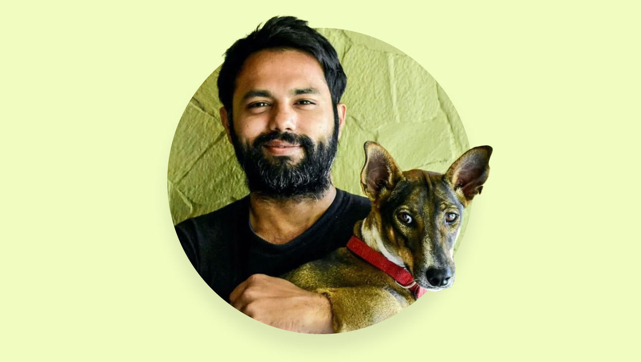 Photo of cartoonist and illustrator Rohan Chakravarty holding dog